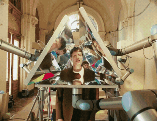 an animated gif of a band performing with mirrors