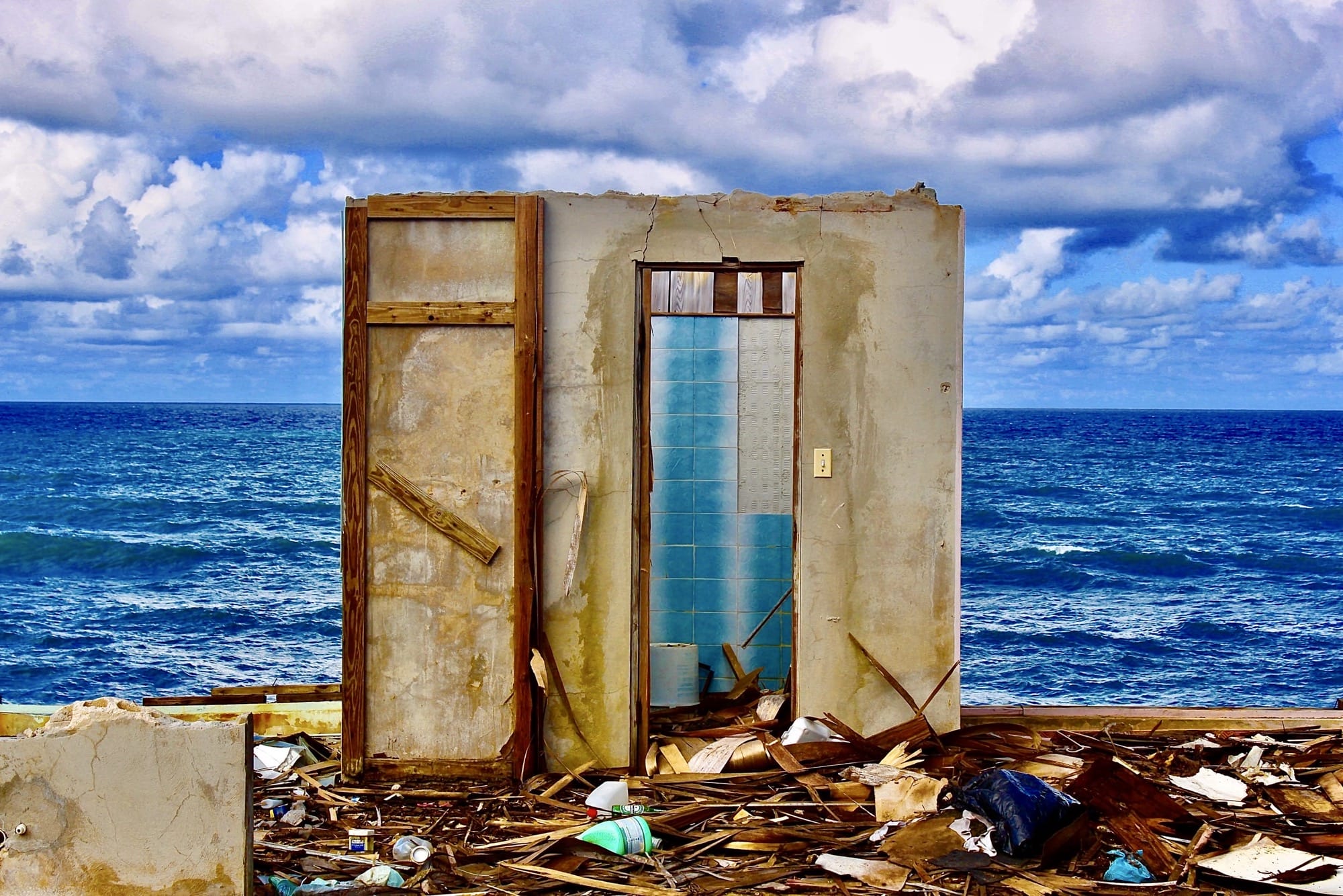 a photograph by Ruben Natal-San Miguel of the ruins of a home on the Puerto Rican coast