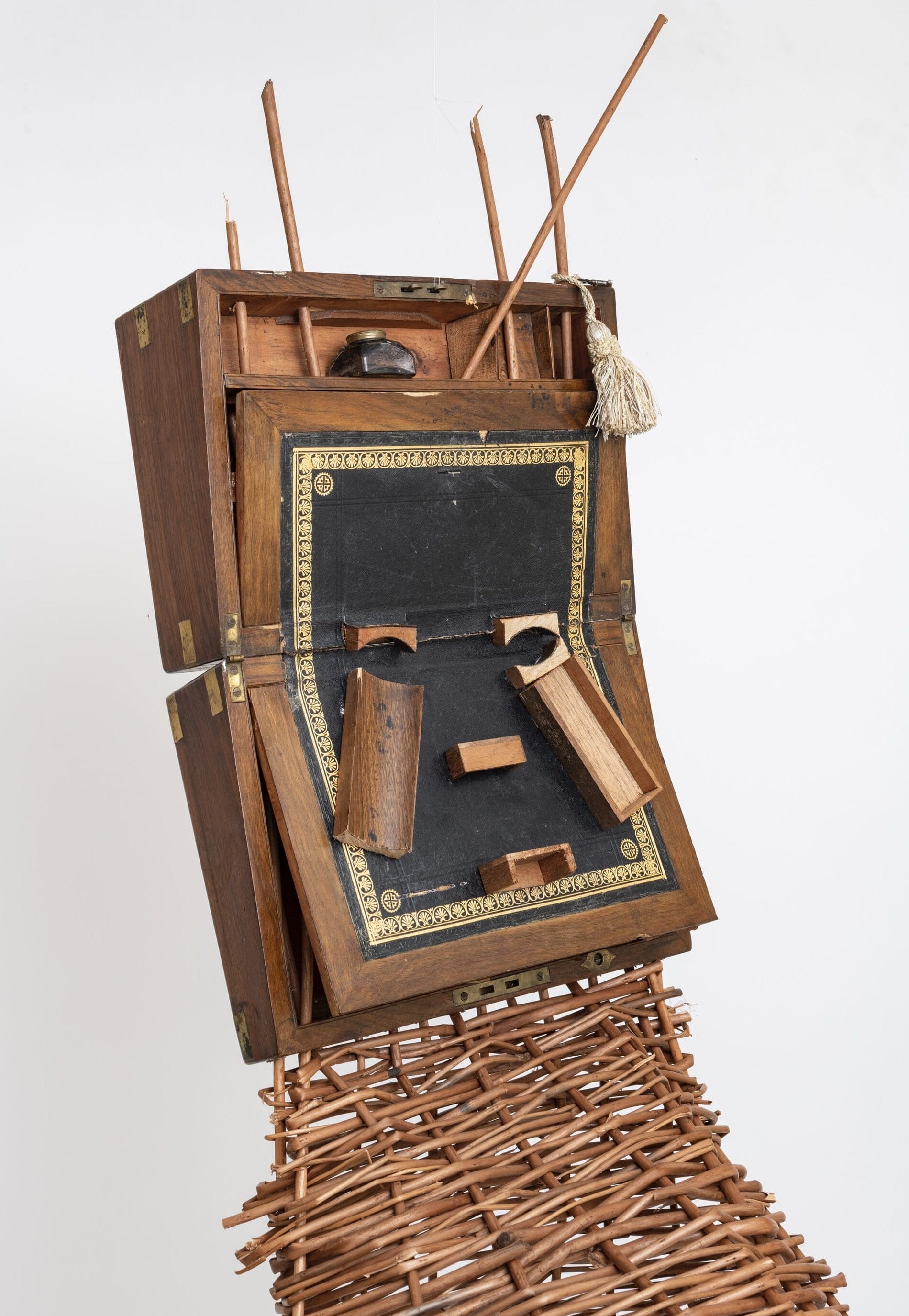 a detail of a sculptural mask inspired by African ceremonial masks, made from a colonial-era writing desk