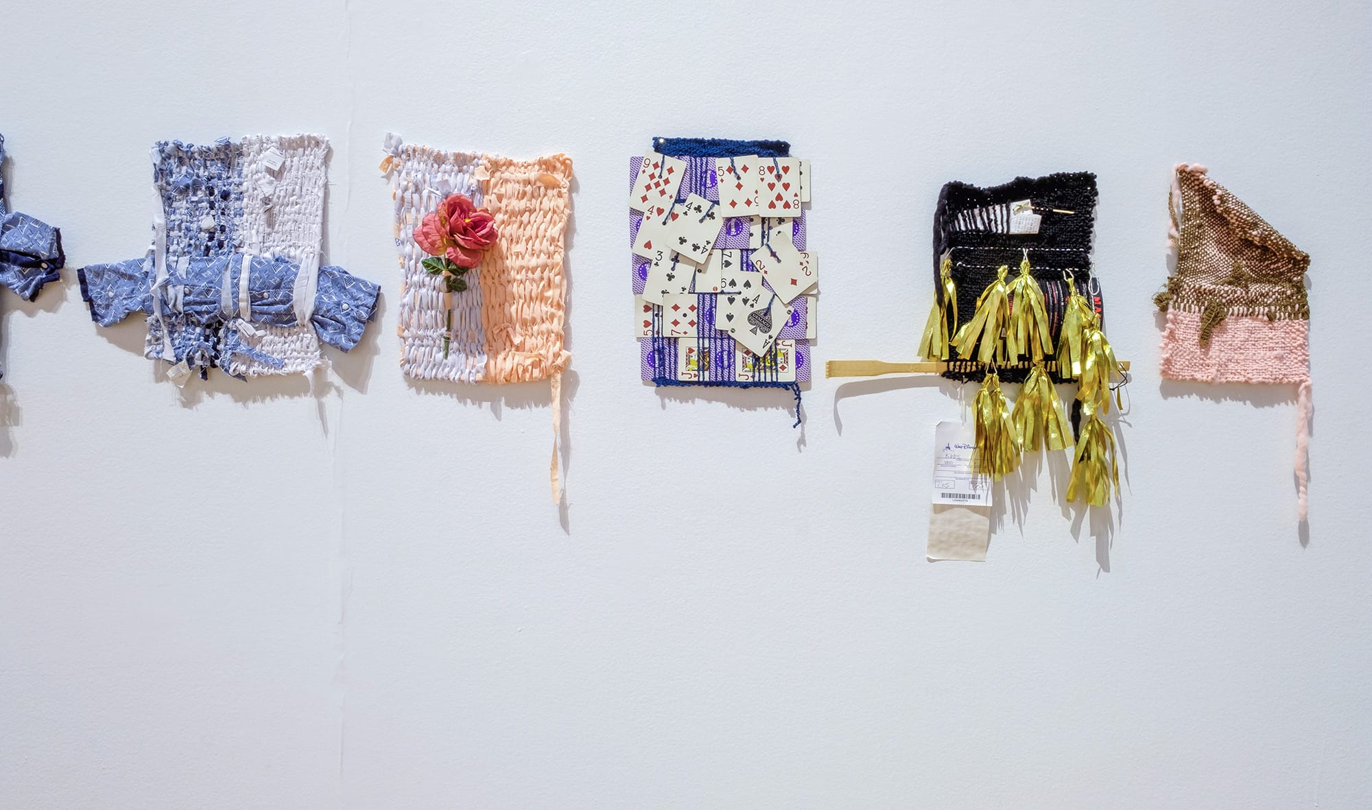 a colleciton of ewavings on a wall