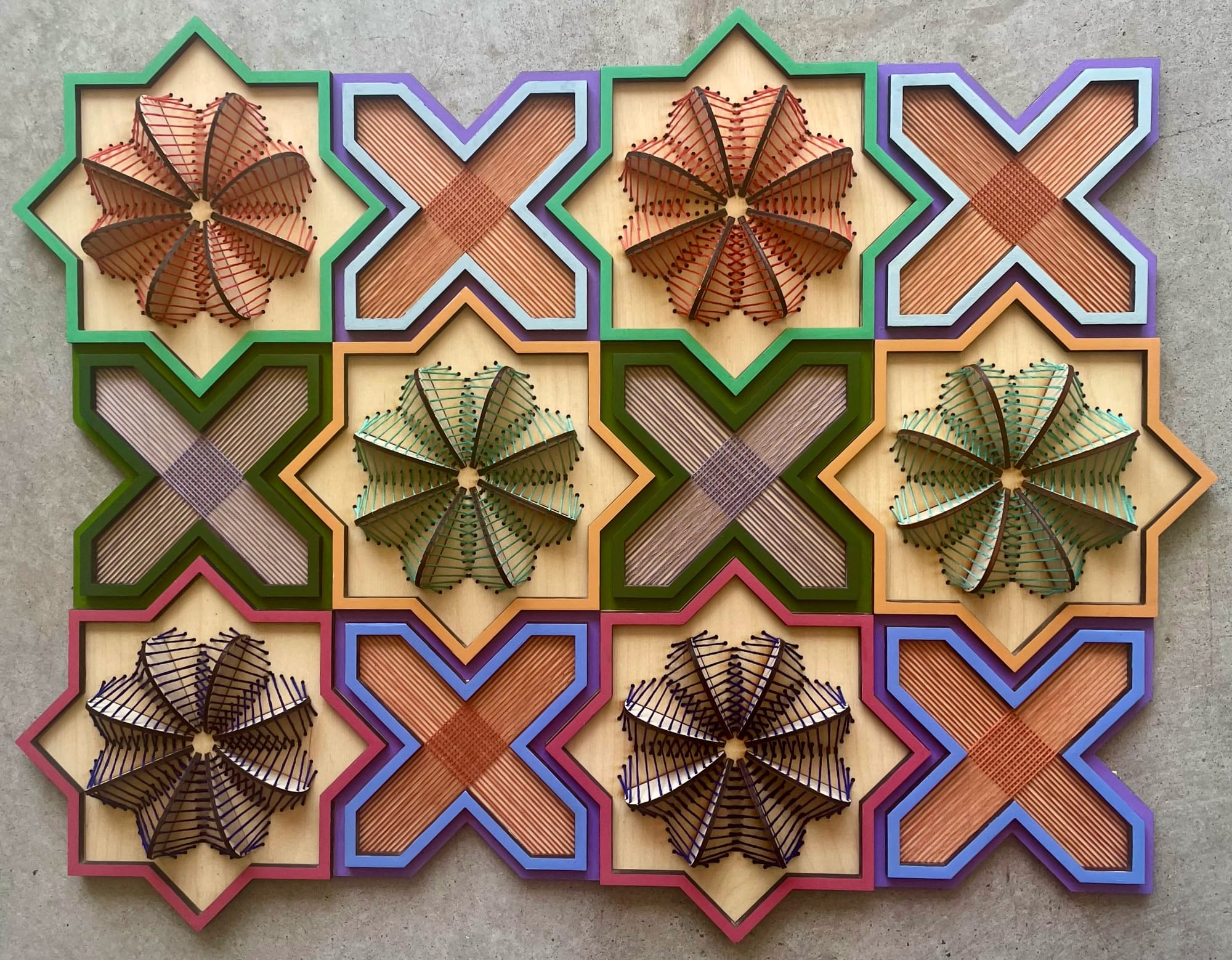 a geometric, sculptural floral embroidery on wood