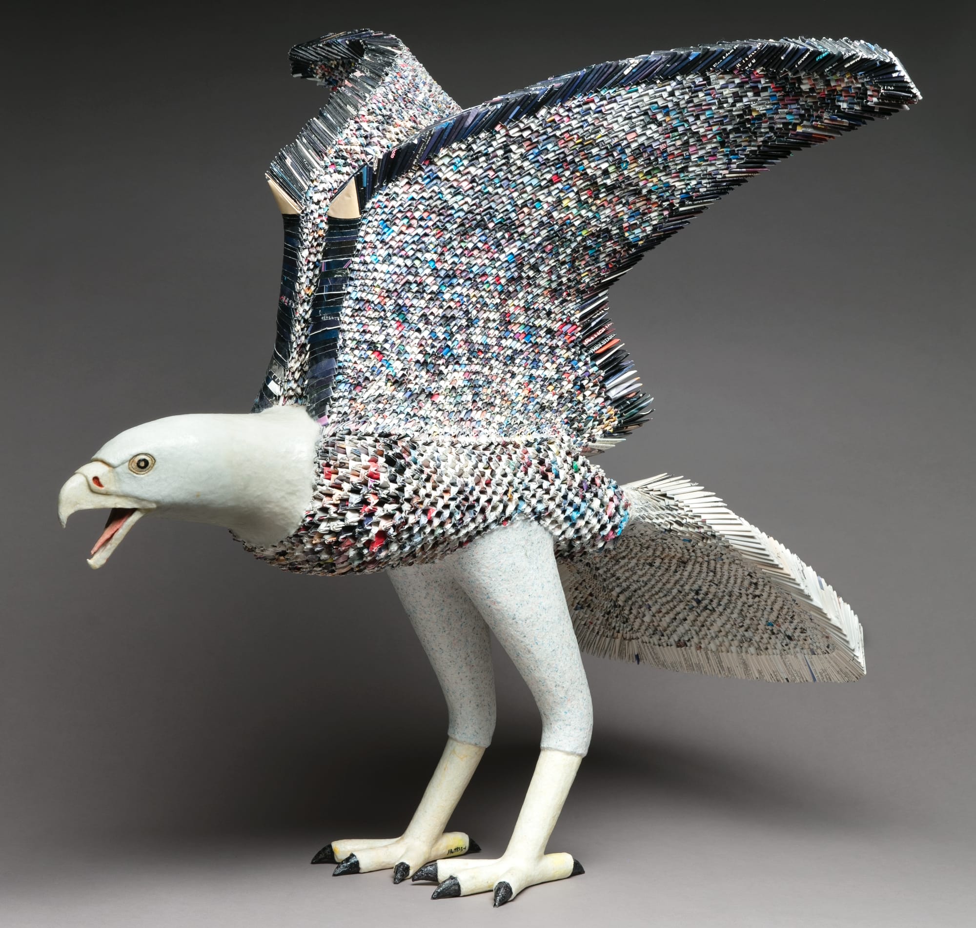 a sculpture of an eagle with spread wings and an open mouth by Djan Shun Lin