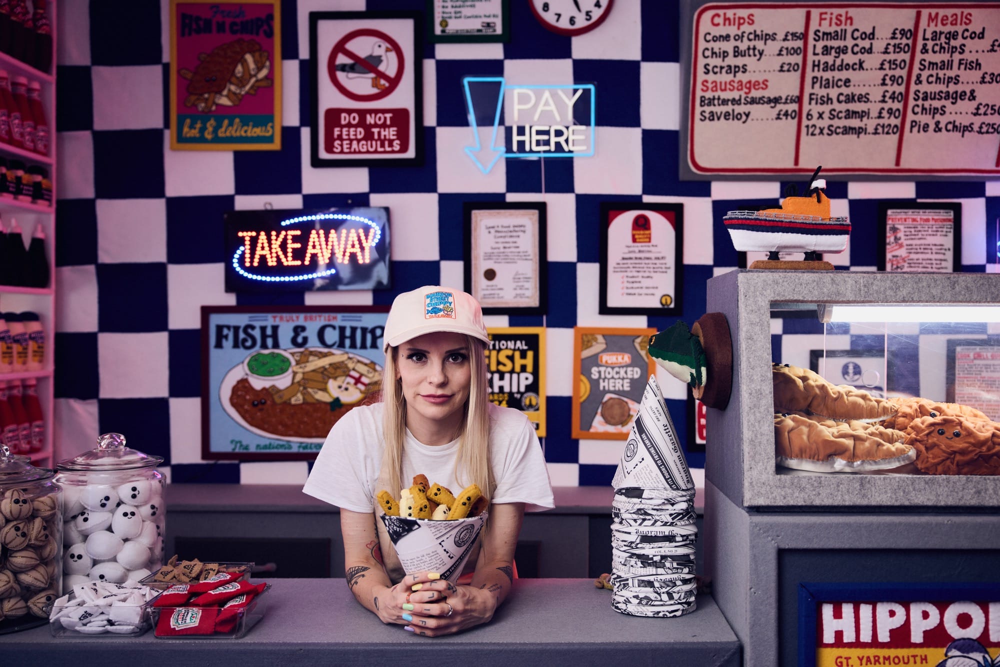 artist Lucy Sparrow in her installation of a fish and chip shop made entirely of felt