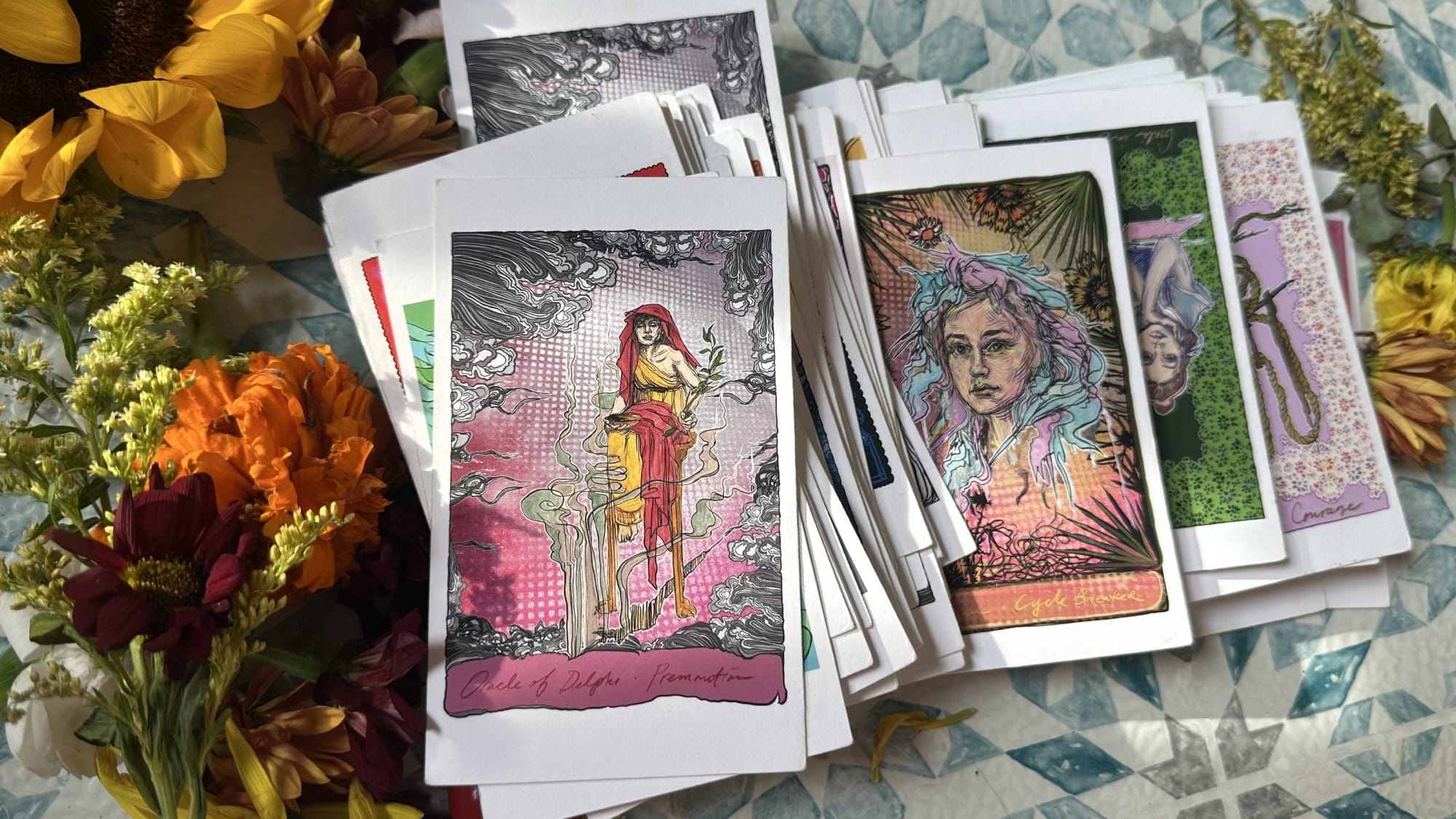 a display of illustrated oracle cards by Swoon
