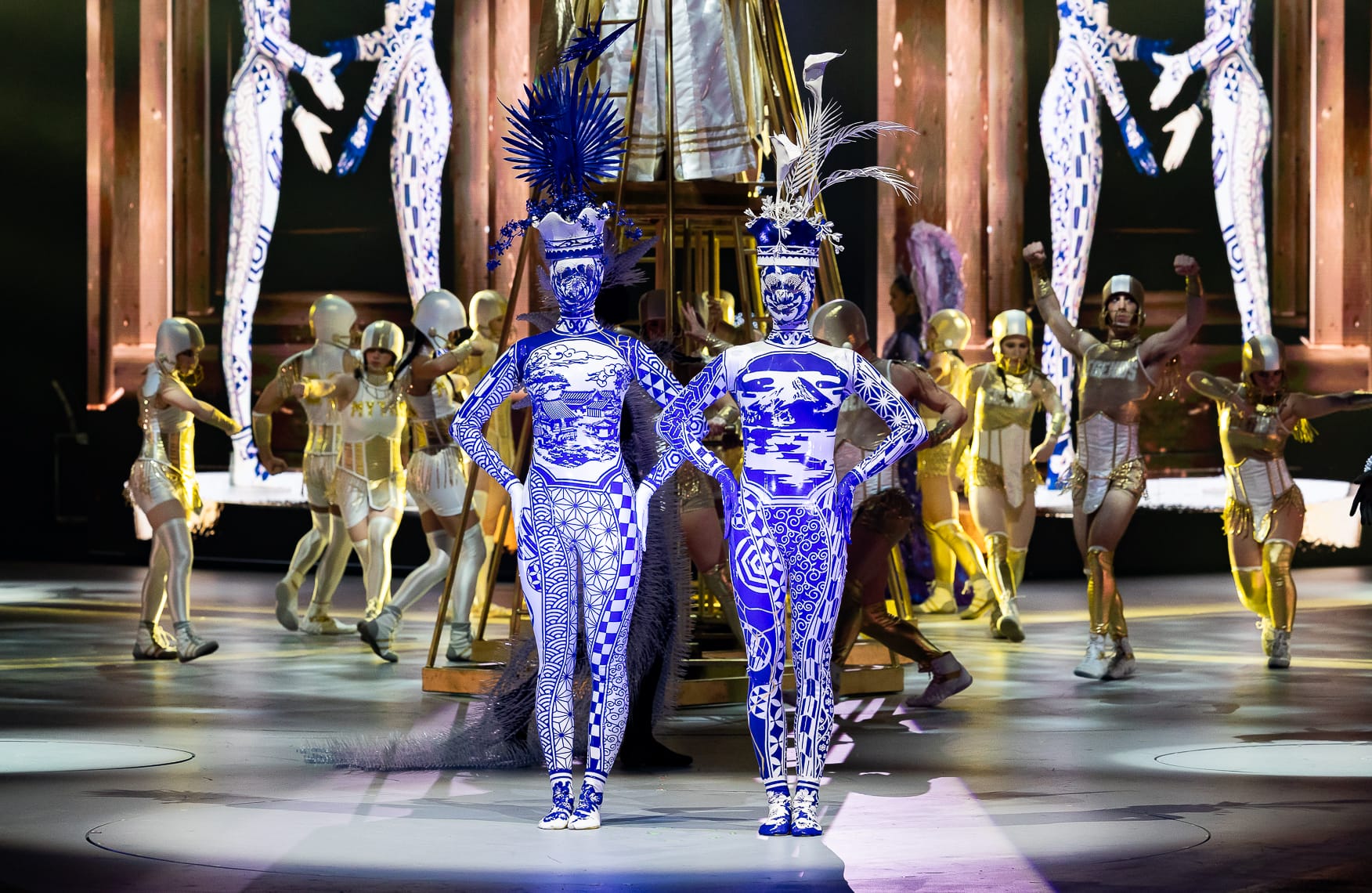 elaborate costumes inspired by blue-and-white vases, worn by two performer on stage